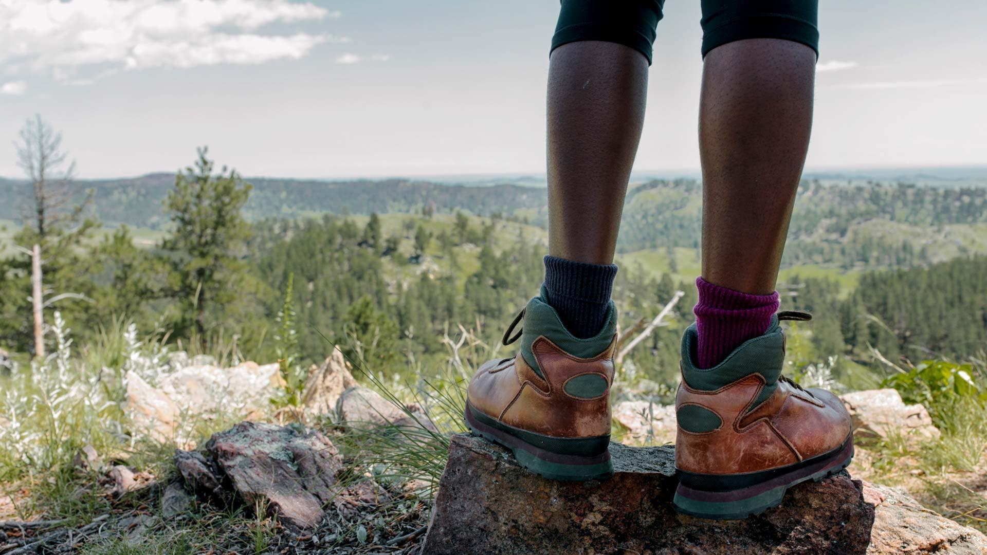 person standing on edge of cliff outdoors